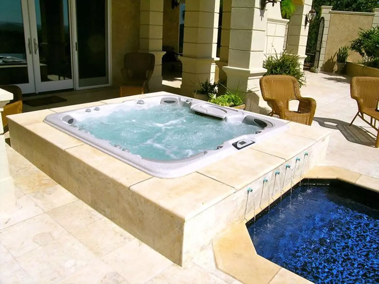 hot tub and pool in backyard